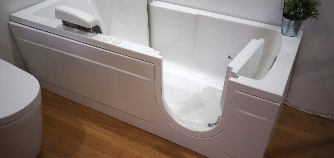 Specialist walking a homeowner through walk-in tub options in her bathroom