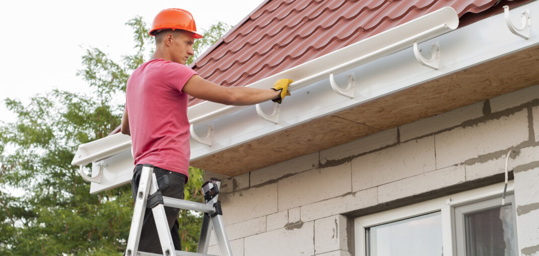 Close-up of seamless gutter being fitted with hidden hangers